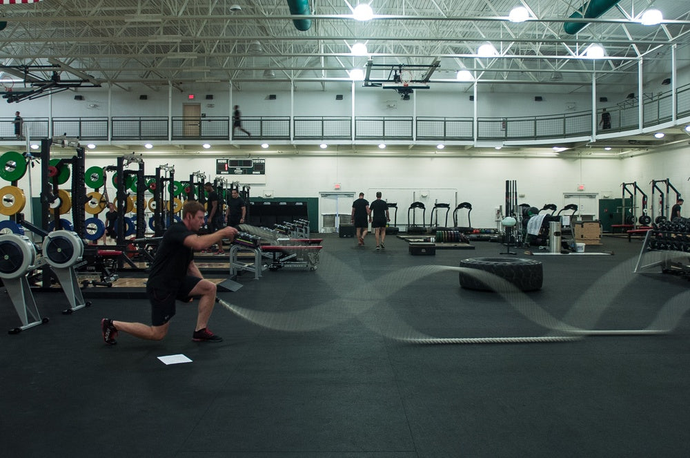 Special Forces soldier performing a loaded lunge with battle ropes
