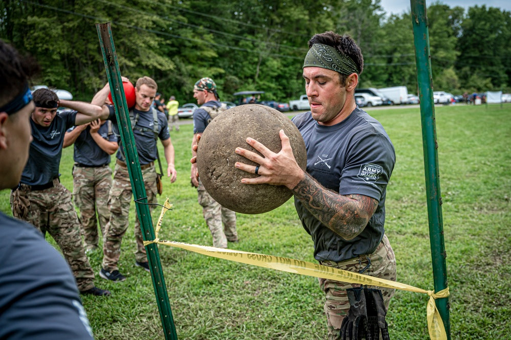 Tactical athlete lifting an Atlas stone during physical training