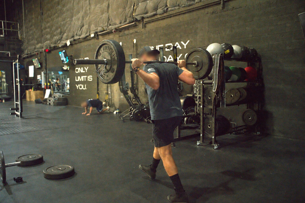 Athlete performing a loaded back squat during performance training